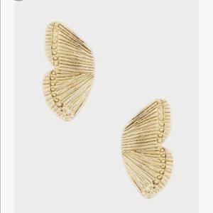 Gold butterfly wing earrings.
